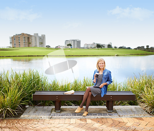 Image of Woman, relax and portrait in park with coffee, book and happy with lunch on bench outdoor in Russia. Girl, smile and sitting at lake with espresso, latte and enjoy break from studying at college