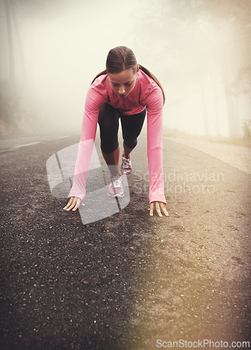 Image of Runner, start and woman on path outdoor in forest, park or woods for exercise in winter. Morning, fog and person with fitness challenge or prepare for workout on road in countryside with nature