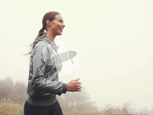 Image of Nature, energy and woman running in fog on mountain road for race, marathon or competition training. Sports, exercise and athlete with cardio workout for fitness in misty outdoor woods or forest.