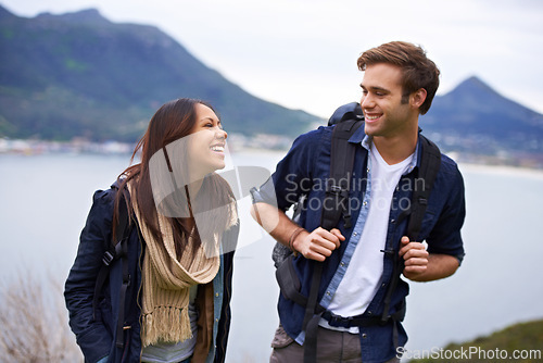 Image of Hiking, nature and couple on mountain laugh with backpack for love, trekking and explore landscape. Travel, dating and happy man and woman by scenic view on holiday, vacation and outdoor adventure