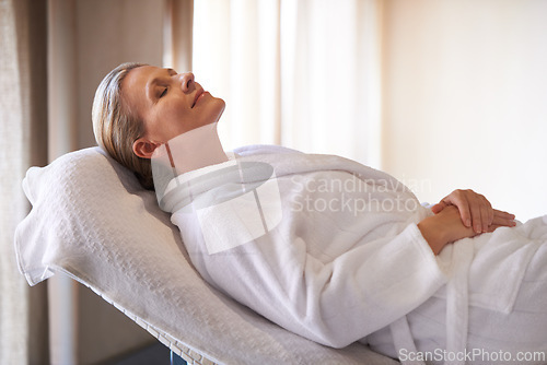 Image of Woman, calm and smile for wellness, spa and healthy weekend getaway at luxury retreat in Amsterdam. Peaceful, holistic and female person for rest on table with robe, eyes closed and happiness