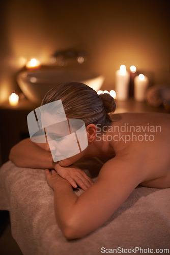 Image of Massage, relax and woman with holiday, spa and stress relief with hospitality industry and weekend break. Person, customer and girl on a table and wellness with beauty and happy with detox or candles