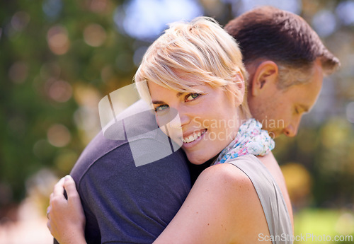 Image of Hug, love and couple in nature with support, commitment and trust, care and solidarity while bonding in a park. Safety, security and people embrace in a garden with peace, calm or soulmate connection