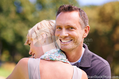 Image of Love, couple and hug in nature with support, commitment and trust, care and solidarity while bonding in a park. Safety, security and people embrace in a garden with peace, calm or soulmate connection