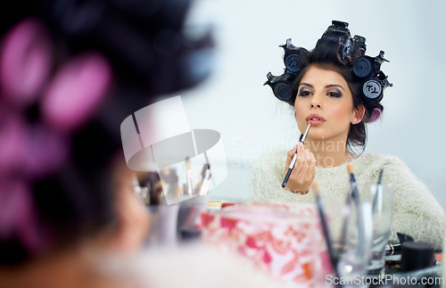 Image of Woman, face and hair curlers or lipstick for beauty in mirror and haircare, self care or cosmetology. Model, person or hairstyle for morning routine, curling or getting ready for wellness or grooming