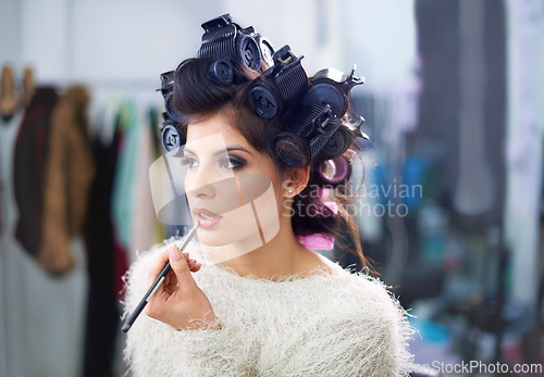 Image of Woman, face or hair curlers with lipstick for beauty in salon with haircare, self care or cosmetology. Model, person or cosmetics brush for morning routine or getting ready for wellness and grooming