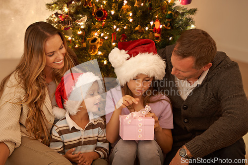 Image of Family, living room and christmas with present, excitement and joy with home on sofa. Parents, children and celebration with gift, gratitude and box with happiness or appreciation for holiday