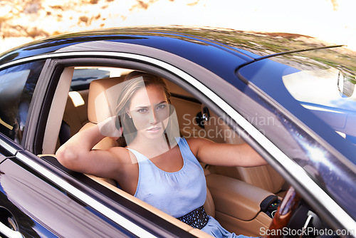Image of Portrait, travel and woman in sports car, driving or road trip with motor vehicle in Canada. Serious person, face and luxury automobile for journey, vacation and adventure in transport for holiday