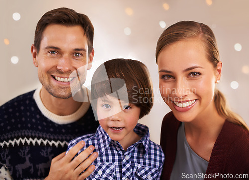 Image of Christmas, family and happy kid with parents in home for love, connection and bonding at festive celebration with bokeh. Xmas, face and child with mother, father and together at party on holiday