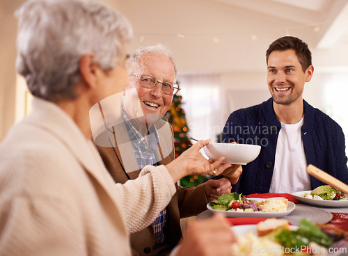 Image of Senior, father and happy with family at Christmas dinner with food and reunion celebration in home. Holiday, event and man smile with lunch, roast dish and relax at dining room table with elderly