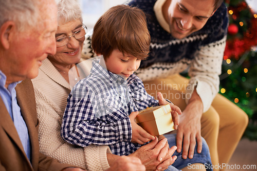 Image of Father, grandparents and child with Christmas gift for festive season celebration for vacation, package or together. Kid, box and happy family in Canada for traditional holiday, bonding or opening