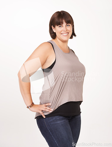 Image of Studio, portrait and plus size woman with confidence for casual fashion to relax in jeans for comfort. Female person, smile and positive with happiness as model in white background of backdrop