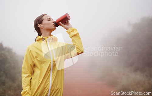 Image of Nature, fitness and woman drinking water for running on dirt road with race or marathon training. Sports, workout and young female athlete enjoying beverage for hydration on outdoor cardio exercise.