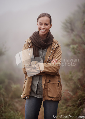 Image of Hiking, portrait and happy woman with arms crossed in nature for travel, wellness or walk outdoor in winter. Face, pride hiker in a forest for fresh air, camping or adventure, journey or campsite fun