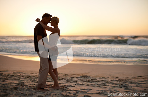 Image of Couple, together and romance at sunset in ocean for peace in trip and vacation. Partners, embrace and relax in sea with water to enjoy, calm and smile for love of marriage in honeymoon and holiday