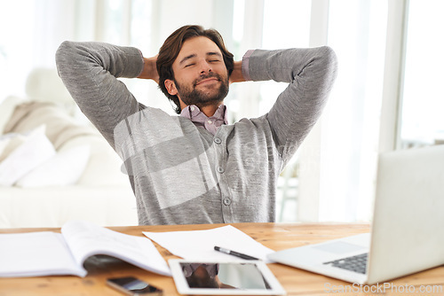 Image of Businessman, relax and paperwork with laptop in house for remote, freelance work and internet research. Male person, hands and head for break, wellness and technology in home office for online job