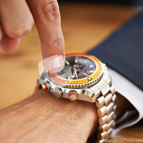 Image of Hands, desk and wristwatch with pointing time for deadline at office, table and schedule for business. Closeup, check and appointment for work with commitment, punctual and plan for meeting.