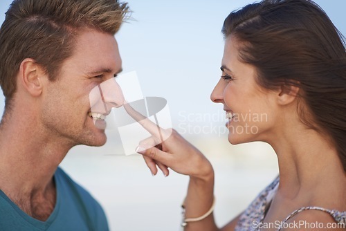 Image of Couple, laugh and touch nose on playful date, romantic getaway or summer vacation in South Africa. Smile, boyfriend and girlfriend in love for sweet relationship, joyful outing and bonding together