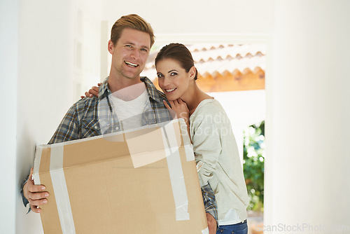 Image of New house, portrait or happy couple with box for moving or excited for investment in real estate. Man, woman and proud homeowner with package by front door and smile face in living room for mortgage