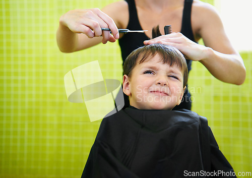 Image of Child, boy and barber with haircut at salon for grooming, hairstyle and unhappy with scissors. Hairdresser, person and kid for hair treatment, haircare and hairdressing with comb or sitting on mockup