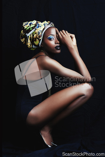 Image of Black woman, beauty and portrait with fashion, turban and makeup in studio. Cosmetics, trendy and afro style with African female person from Kenya with traditional head dress with black background