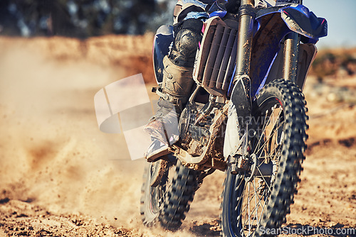 Image of Closeup, dirt track and wheels of motorcyclist with motorbike for race, extreme sports or outdoor competition. Legs of expert rider on bike, scrambler or sand course for off road rally challenge