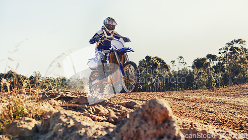 Image of Stunt, race and man on dirt bike in desert with adventure, adrenaline and speed in competition, Extreme sport, trick and athlete on off road motorcycle for challenge, power or danger on action course