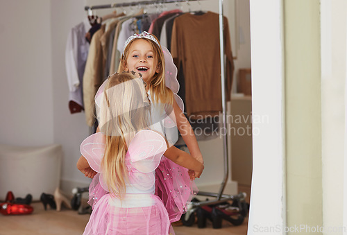 Image of Girl, sister and face with fairy costume in bedroom of home for dress up, fantasy play and tiara with dancing. Family, children and holding hands with princess outfit for bonding, rear view and wings