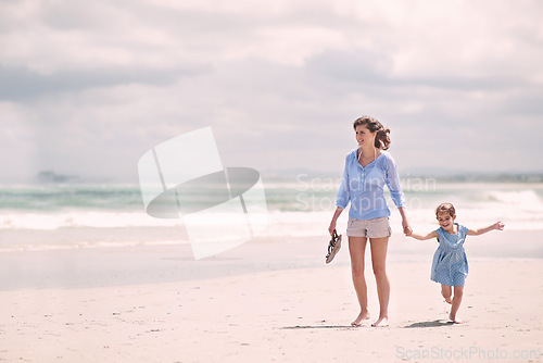 Image of Mother, child and hand holding on beach travel or explore environment or windy summer or holiday, weekend or bonding. Female person, daughter and relax at Australia seaside or peace, vacation or trip