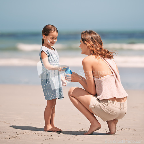 Image of Mother, child and sunscreen with skincare health on beach for summer holiday, tropical island or bonding. Female person, daughter and lotion application at California seaside, protection or safety