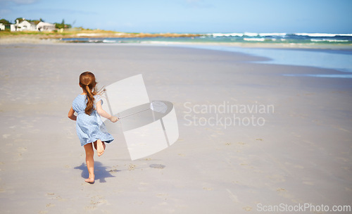 Image of Child, beach and running with fishing net or nature explore in summer or vacation adventure, environment or rear view. Female person, kid and seaside in Florida for holiday destination, ocean or trip