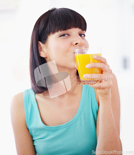 Image of Portrait, orange juice and woman with drink for healthy diet, nutrition and wellness in home. Face, glass and person with beverage, vitamin c and organic fruit liquid for breakfast in the morning