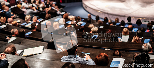 Image of Business and entrepreneurship symposium. Audience in conference hall. Rear view of unrecognized participant in audience.