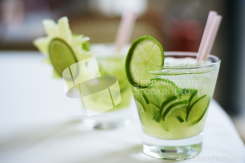 Image of Cocktail, alcohol and glass with fruit for mojito drink on table for party, club and bar. Mockup, background and closeup of mocktail, beverage and liquid with lime, ice and liquor for celebration