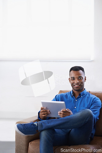 Image of Man, tablet and online in portrait at home, subscribe and internet for website or blog. Black male person, smile and streaming entertainment on couch, mockup space and app for shopping on weekend