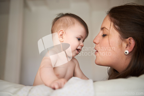 Image of Mother, baby and love connection in home with parenting bonding on bed for childhood development, support or safety. Kid, female person and together for young nurture or nursery, relax or security