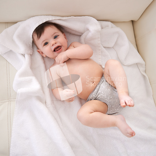 Image of Portrait, baby and boy with diaper, top view and smile with blanket or relaxing with happiness. Face, infant or child with newborn or laugh with wellness or healthy with nappy or joy with kid or home