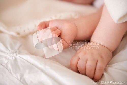 Image of Baby, hands and fingers on bed as closeup for childhood development or nursery sleeping, relax or resting. Kid, wellness and childcare in home for wellbeing nap or dreaming nurture, caring or calm