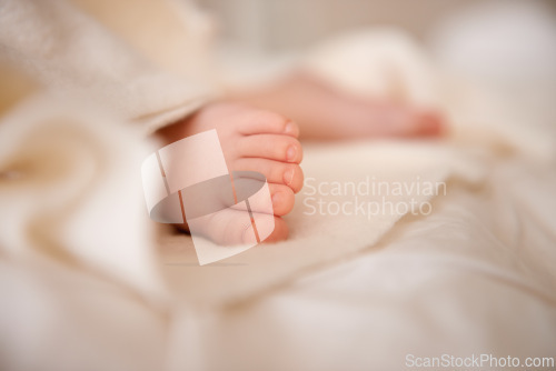 Image of Baby, feet and toes or blanket as closeup for childhood development or nursery sleeping, relax or resting. Kid, wellness and childcare on bed for wellbeing nap or dreaming nurture, caring or calm