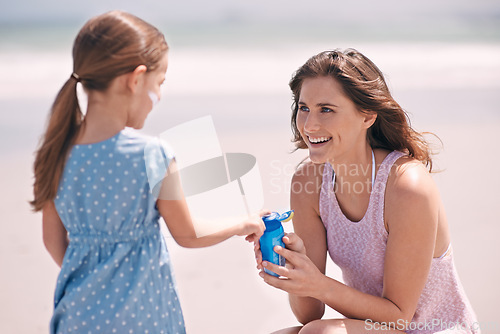 Image of Happy mother, girl and sunscreen bottle at beach for summer holiday, vacation or travel. Child, kid and mom apply sunblock cream outdoor for protection, health or skincare of family laughing together