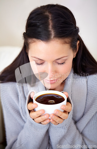 Image of Aroma, coffee and woman with drink in home, calm or relax for breakfast in the morning. Smell, latte and person with espresso in cup, beverage and fresh cappuccino with eyes closed for peace in house