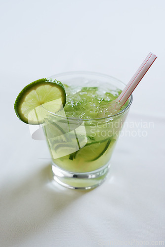 Image of Cocktail, alcohol and glass with lime for mojito drink on table for party, club and bar. Mockup, background and closeup of mocktail, beverage and liquid with fruit, ice and liquor for celebration