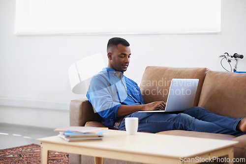 Image of Man, laptop and internet for remote work at home, freelancer and copywriting in living room. Black male person, online and plan on tech or connection for website, information and research for article