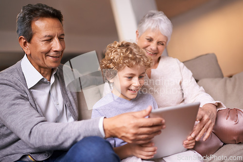 Image of Happy family, grandparents and little boy with tablet for entertainment, social media or research on sofa at home. Grandma, grandpa and child smile on technology for online search or movie at house