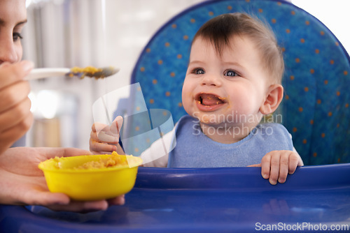 Image of Baby, parent and spoon for feeding food in chair for morning nutrition in apartment for breakfast, development or lunch. Kid, childcare and fingers for toddler dinner or wellness, hungry or vitamins
