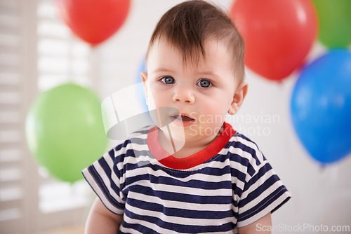 Image of Baby, portrait and balloons or birthday party celebration on special day or decoration, inflatable or development. Childhood, boy and face at home or milestone event or growth youth, relax or weekend