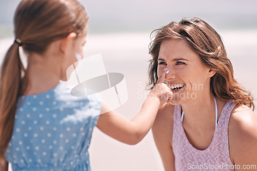 Image of Happy mother, child and sunscreen on nose at beach for summer holiday, vacation or travel. Mom, kid and apply sunblock cream outdoor for protection, health and skincare of family laughing together