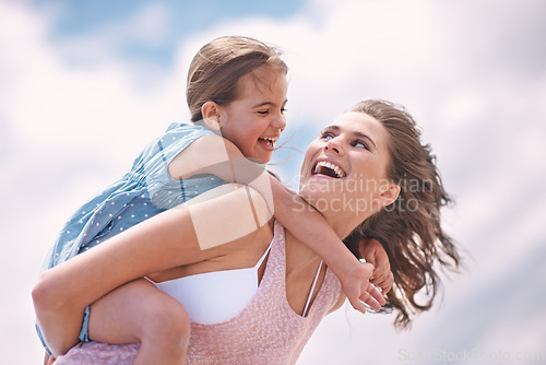 Image of Mother, daughter and piggyback or happy on the beach for bonding and love, travel and vacation in Mexico. Freedom, care and trust, woman and girl kid play game with joy and family together outdoor