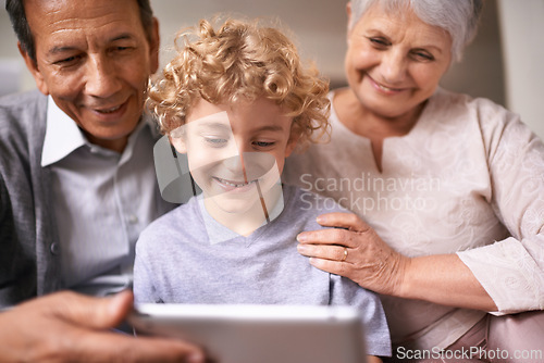 Image of Happy family, grandparents and child with tablet for entertainment, social media or research on sofa at home. Grandma, grandpa and little boy smile on technology for online search or movie at house