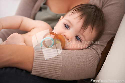 Image of Baby, parent and relax in arms with pacifier for childhood development or growth safety with love, caring or resting. Kid, dummy and together in apartment for bonding support, security or comfort